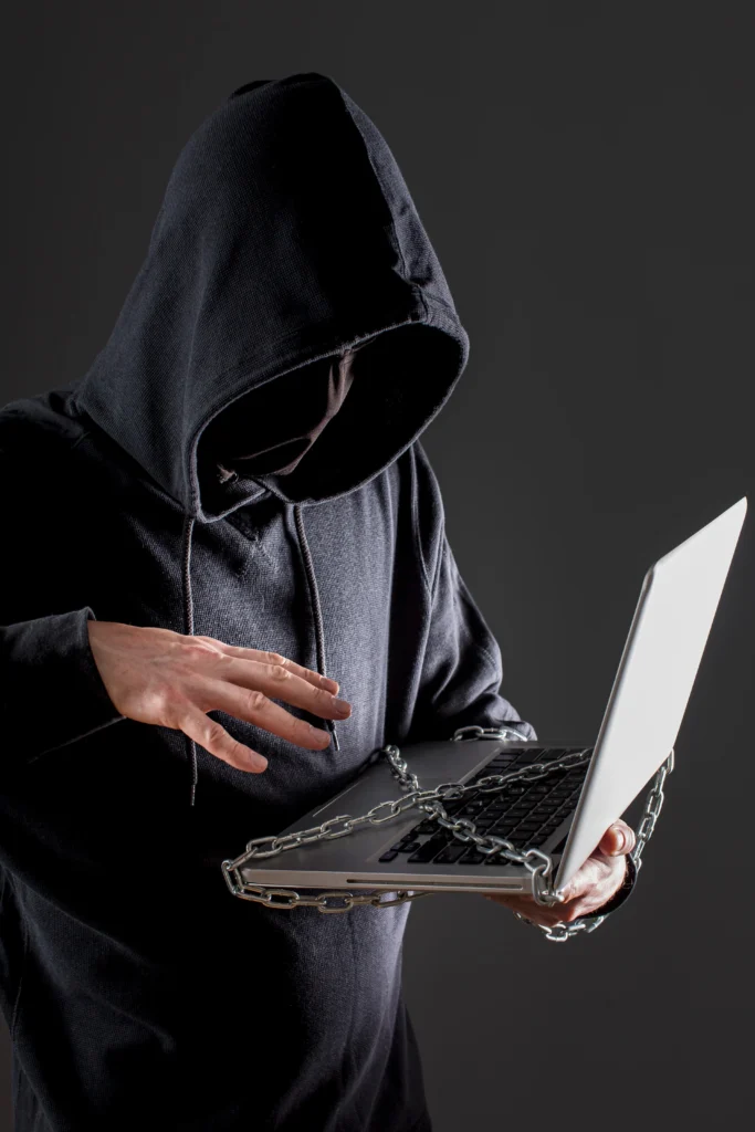 side-view-male-hacker-with-laptop-protected-by-metal-chain