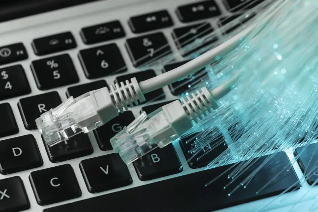 blue-optic-fiber-with-ethernet-cables-laptop